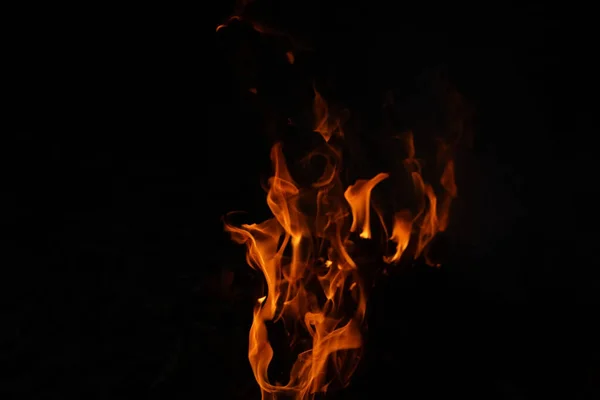 燃烧的火焰或在黑色背景上隔离的火 夜间热能量特写 红色和黄色 热能量点燃燃料 黑色背景下的光 — 图库照片