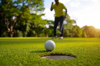 Bulanık golfçü akşam vakti golf sahasında golf oynuyor. Golfçüler akşam golf sahasına golf koyuyorlar. Spor tatil yaşam tarzı kavramı.