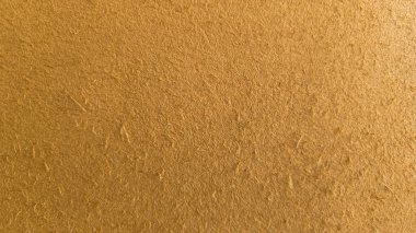 Duvarın arka planı sarı-kahverengi. Dokulu alçı kabuk böceği. Soyut kahverengi arkaplan dokusu duvarı