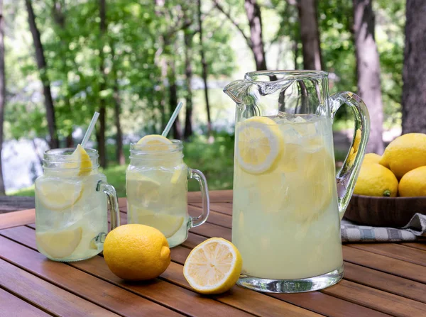 Pitcher Lemonade Lemon Slices Ice Outdoors Wooden Table Nature Background — Stock Photo, Image