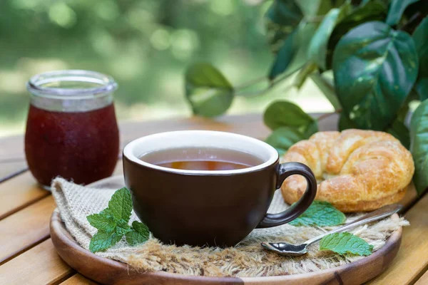 Cup Tea Mint Leaves Croissant Jar Jam Outdoors Wooden Patio — Stock Photo, Image