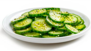 Fresh cucumber slices drizzled with sesame seeds, creating a light and refreshing dish perfect for any meal. clipart