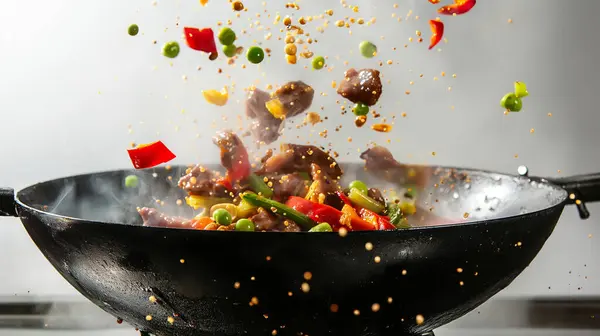 stock image Stir-fried vegetables and meat being tossed in a wok, capturing the dynamic action and vibrant colors of cooking.