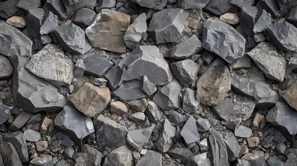 stock image A pattern of gray and black stones tightly packed together, forming a uniform, textured surface.