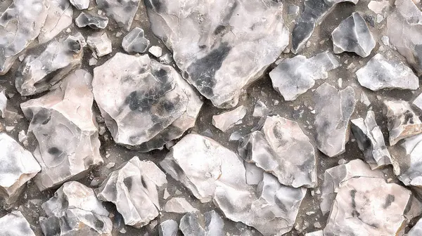 stock image A pattern of rough, light gray stones with a rugged, natural texture, resembling a rocky surface.