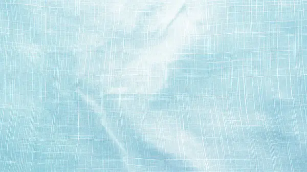 stock image A close-up view of blue linen fabric with visible weave patterns, showcasing texture and softness, set against a light background.