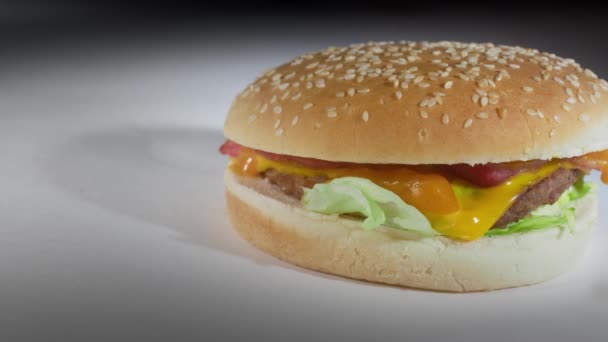 Unappetising Microwaveable Bacon Cheeseburger Sesame Seed Bun Captured Plain White — Stock Video