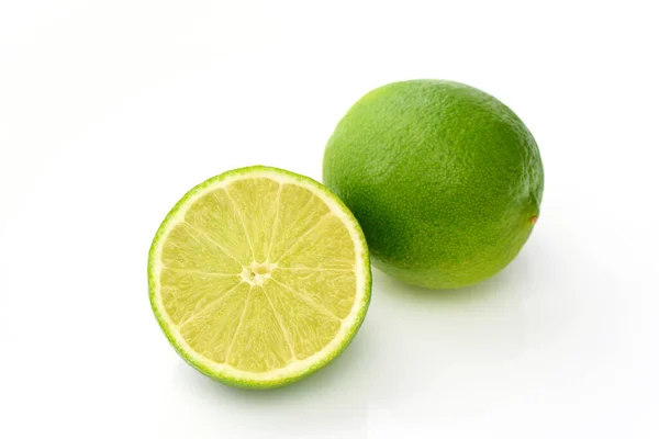 stock image whole lime and sliced lime on white background with shadows