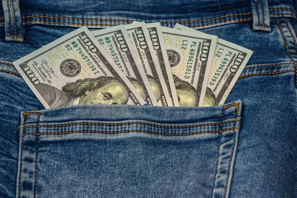 100 dollar pocket money, in jeans pocket, 100 dollar bills
