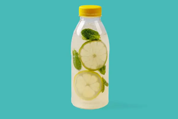 Mojito lemonade with lemon, lime, mint, mojito syrup, ice, sparkling water on green background for food delivery website