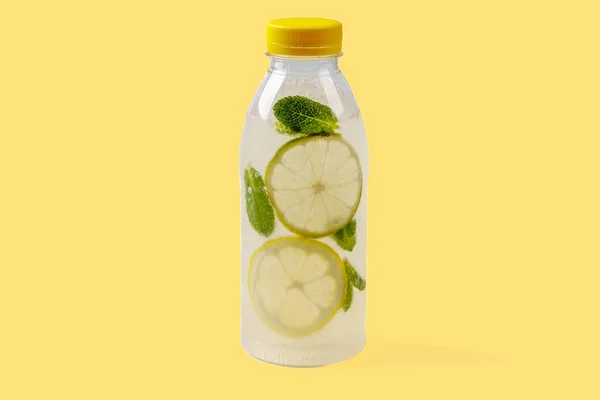 Mojito lemonade with lemon, lime, mint, mojito syrup, ice, sparkling water on yellow background for food delivery website