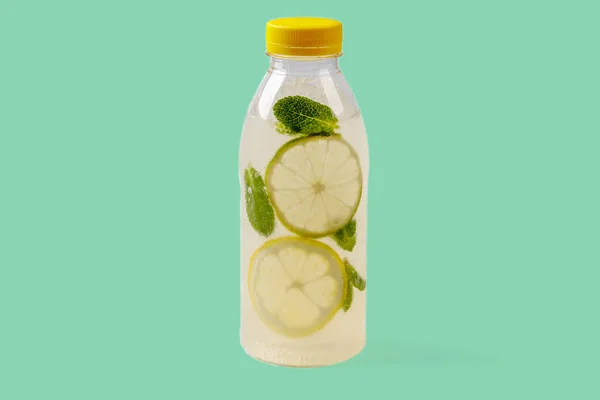 Mojito lemonade with lemon, lime, mint, mojito syrup, ice, sparkling water on green background for food delivery website 1