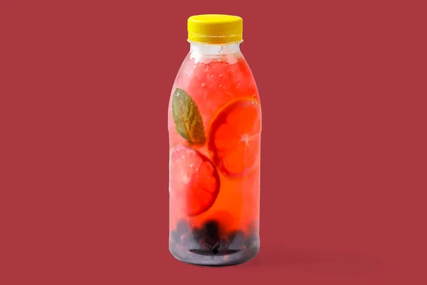 Bubble gum lemonade with currants, lime, mint, bubble gum syrup, ice, soda water on red background for food delivery website