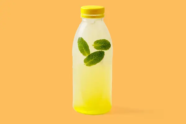 Melon lemonade with melon puree, mint, melon syrup, ice, sparkling water on a yellow background for food delivery website
