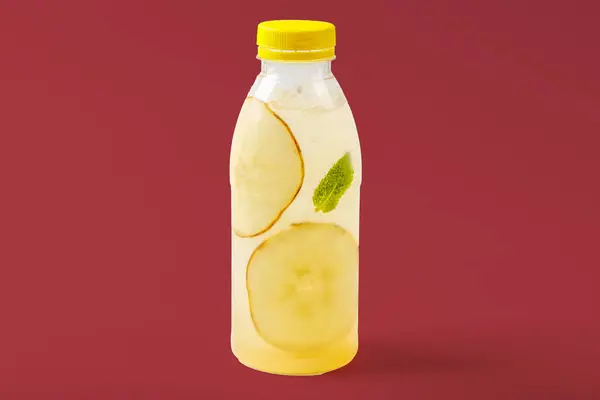 Duchess lemonade with pear, mint, pear syrup, ice, sparkling water on red background for food delivery website