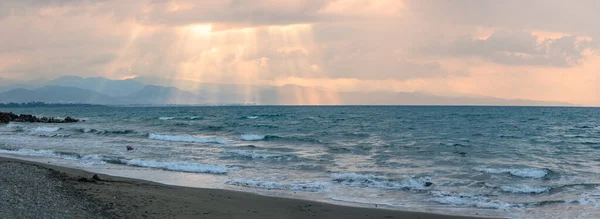 sunlight through the clouds of autumn sunset evening on the Mediterranean sea against the backdrop of mountains 3