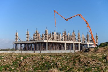 Deniz kenarındaki yeni bir tesisin inşaat sahasına beton dökmek için kullanılan makine.