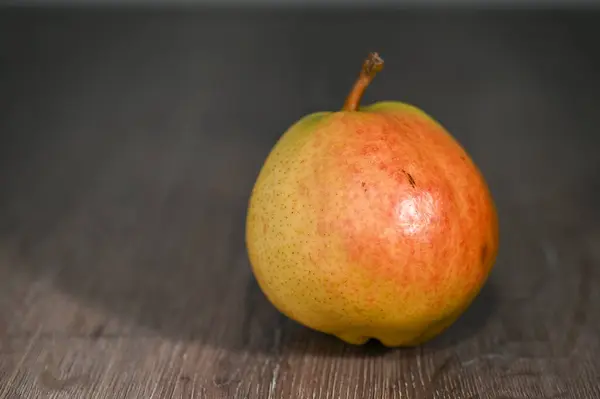 juicy pear on a wooden table studio shooting