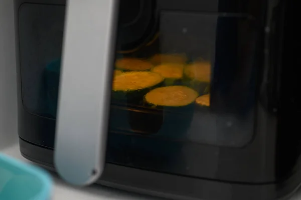Zucchini is fried in an air fryer in the kitchen 2