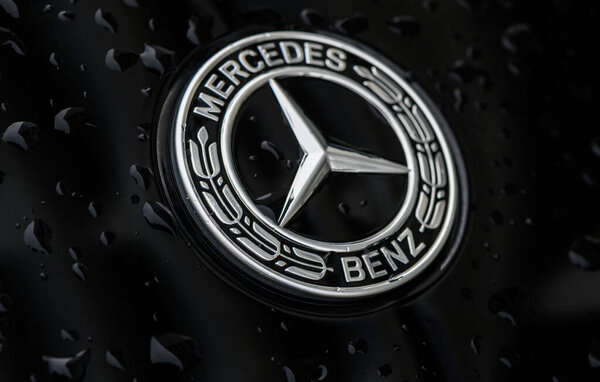 Chernigov Ukraine 13.03.2024-Close-up of the blue round Mercedes Benz logo on the hood of a black car 3