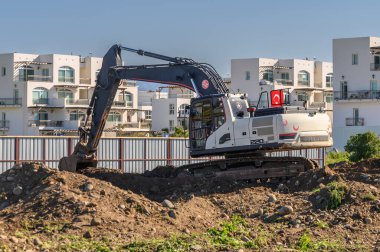 Excavator digging soil at a construction site 2 clipart