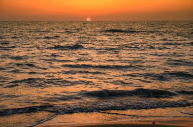 Golden hour shot of the sun setting over the Mediterranean Sea