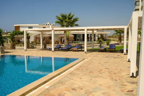 stock image Modern pool area at a Mediterranean villa with sun loungers - luxury relaxation and outdoor living