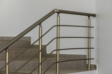 A sleek and stylish stair railing catches the eye in a modern home, providing both safety and artistic flair while complementing the minimalist design. clipart