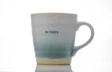 A beautifully designed ceramic mug with the phrase Be Happy inspires joy while resting on a minimalist surface. clipart