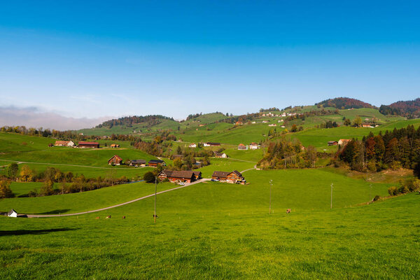 Typical landscape in the Appenzellerland with farm houses, meadows and pastures, Canton Appenzell Innerrhoden, Switzerland