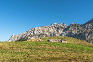 Farmhouse and meadows with view to the Saentis, Canton of Appenzell Ausserrhoden, Switzerland clipart