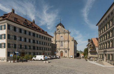 Trogen, Canton of Appenzell Ausserrhoden, Switzerland - April 14, 2024. Village square (Landsgemeindeplatz) with Zellweger Palace and Protestant church clipart