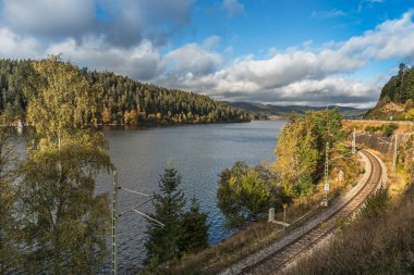 Schluchsee in autumn, view of railroad track along the shore of the lake, Black Forest, Baden-Wuerttemberg, Germany clipart