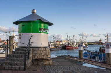 Pier light and fishing boats at the harbor in Buesum, Dithmarschen, Schleswig-Holstein, Germany clipart