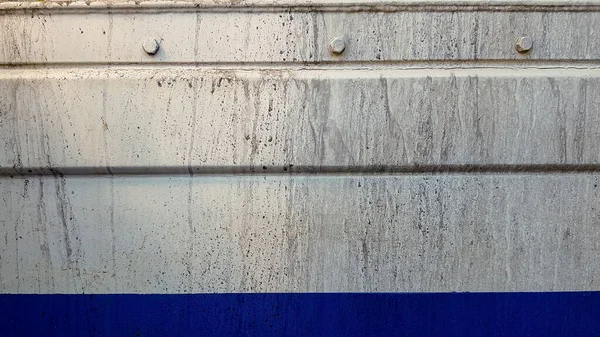 Dirty and colored metallic wall of a container