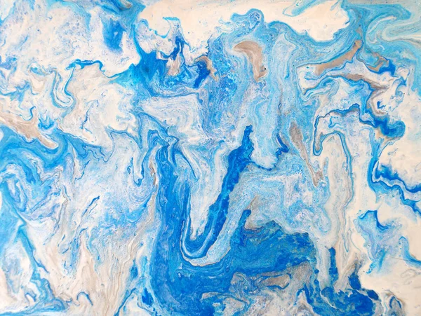 liquid acrylic fluid art close up.  Blue liquid marble effect, modern fluid art. Blue and gold abstract painted background. Drawing Creative wallpaper, beautiful design. Waves effect, trendy wash draw