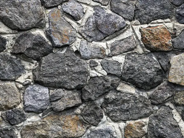 Gray stone wall texture. Wide panoramic rock pattern. Natural masonry surface, brick frame. Grey wall background grunge texture. decorative uneven cracked real stone structure. Design element.
