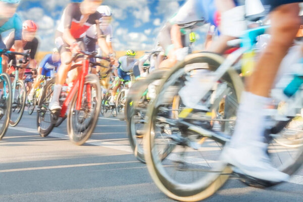 Group of Cyclists During a Race sunlit, mtion blur, overcast sky in the background