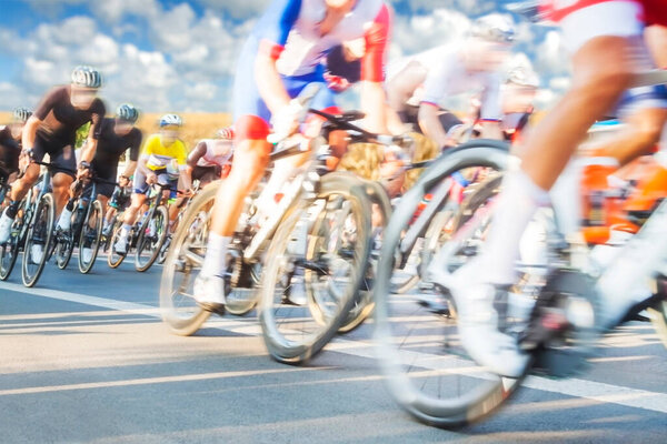 Group of Cyclists During a Race sunlit, mtion blur, overcast sky in the background