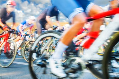 Group of Cyclists During a Race sunlit, motion blur, overcast sky in the background