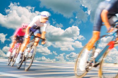 Group of Cyclists During a Race sunlit, motion blur, overcast sky in the background