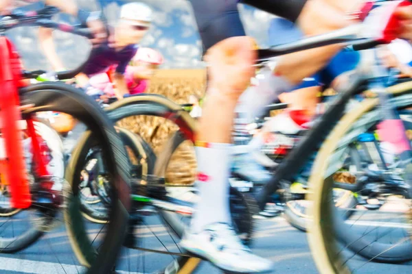 Group of Cyclists During a Race sunlit, motion blur, overcast sky in the background