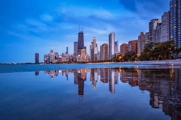 stock image chicago skyline reflected on concrete beach during blue hour