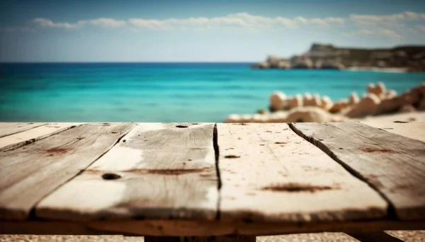 A wooden table with a view of the ocean in the background with a blurry image of a beach deep depth of field a tilt shift photo new objectivity