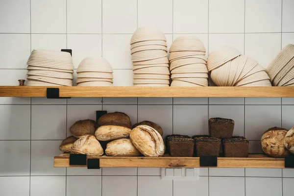Interior details at the bakery and coffee shop. Bistro showcase with shelves with freshly baked baking. Zero waste shop or sustainable local small businesses at food service.