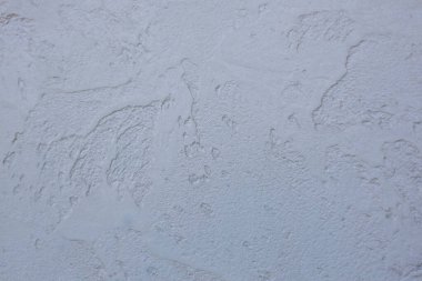 Boya kaplı macun desenli bir duvarın arka planı. Yüzeyin macunla kaplı soyut dokusu.