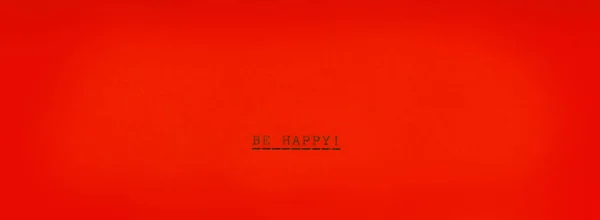 Be happy! on horizontal red paper. Real typrewrite.