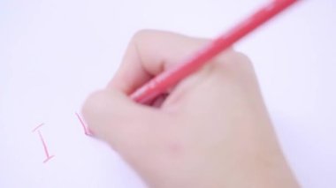Woman drawing i love you inscription and red heart shape on white paper, togetherness concept, Valentines day, love, relationship concept