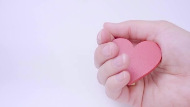 Closeup Female Hand Holding Red Heart Isolated White Pastel Background — Vídeo de stock