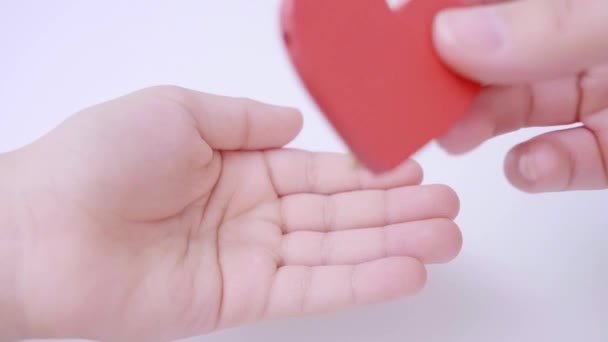 Close Mother Hand Giving Her Child Red Heart White Pastel — Stockvideo